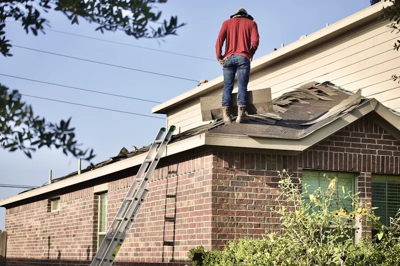 Professional roofer working on a residential roof in Arndts
